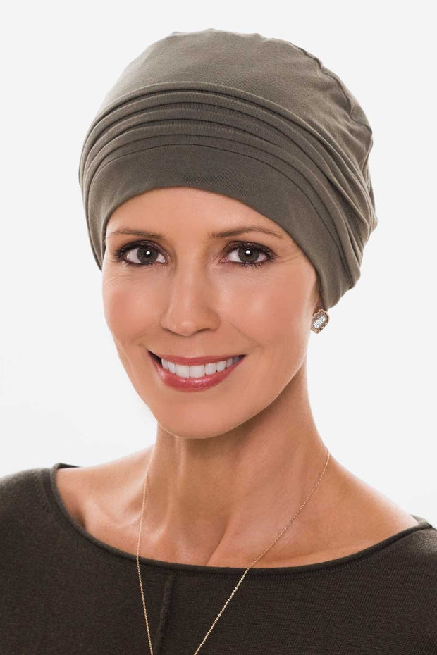 Woman in olive chemo cap with pleating at crown for cancer patients