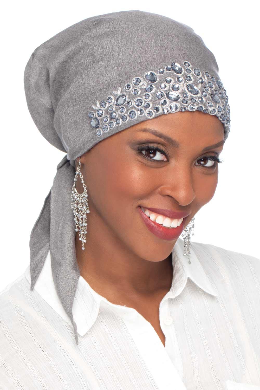 Woman in pretty grey beaded pre tied head scarf for cancer patients
