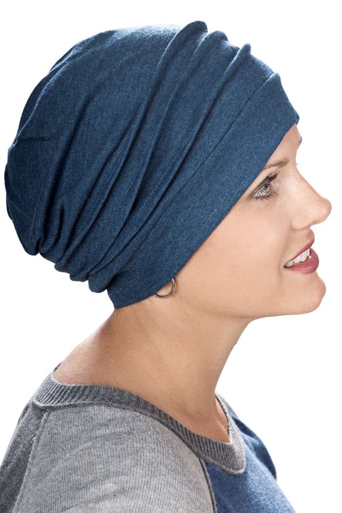 Woman wearing blue slouchy snood hat for cancer patients showing multiple pleats on the side