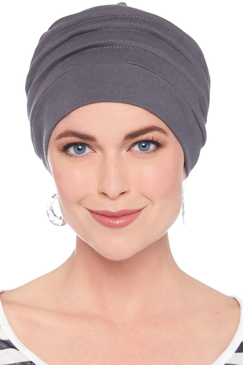Woman in grey snood style chemo hat with pleats