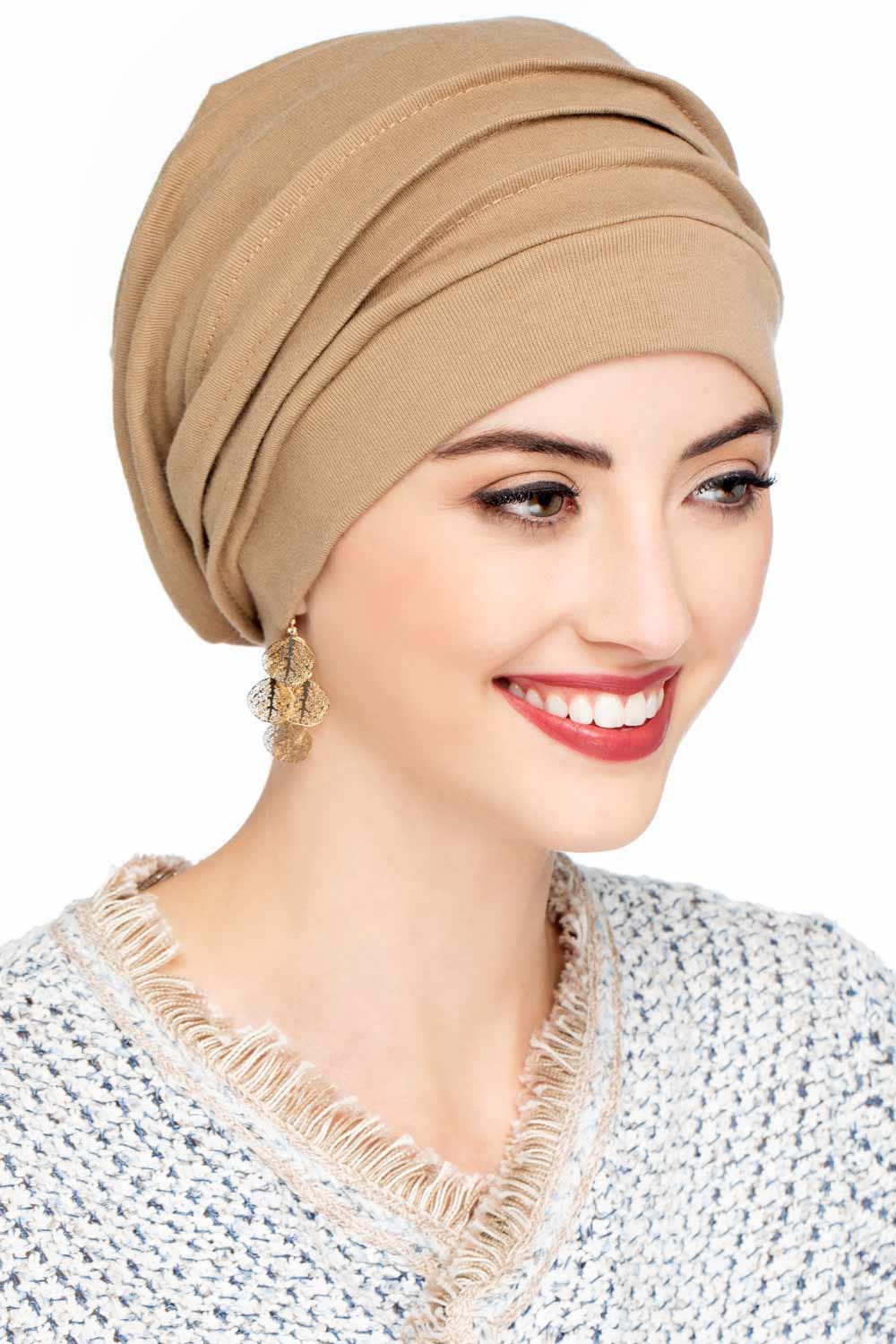 Smiling woman wearing beige slouchy style snood hat