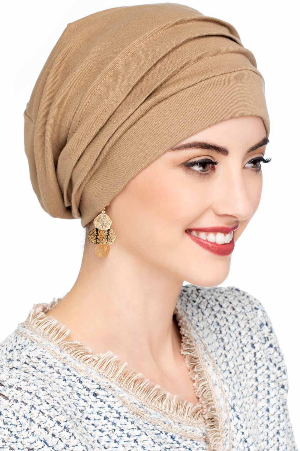 Woman in beige slouchy snood style hat with pleats