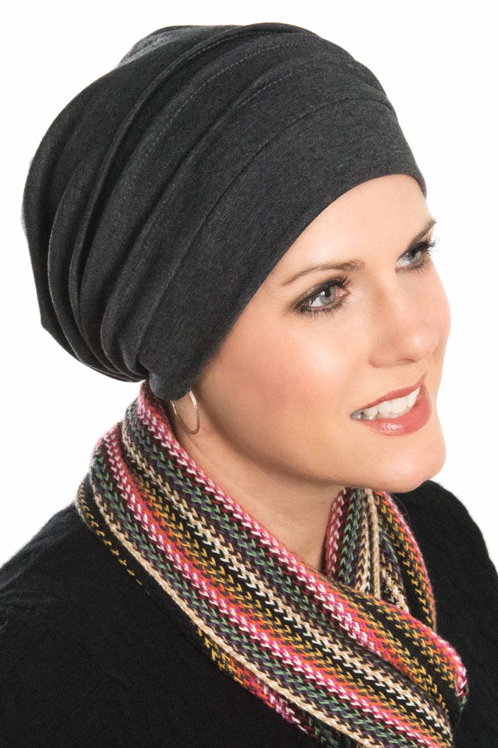 Grey slouchy snood head covering worn by a woman with a scarf