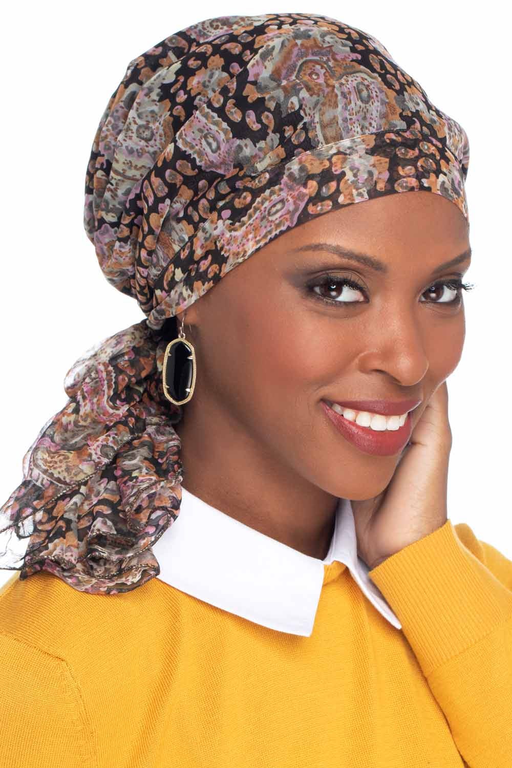 Woman in black paisley pre tied head scarf headcovering for cancer patients
